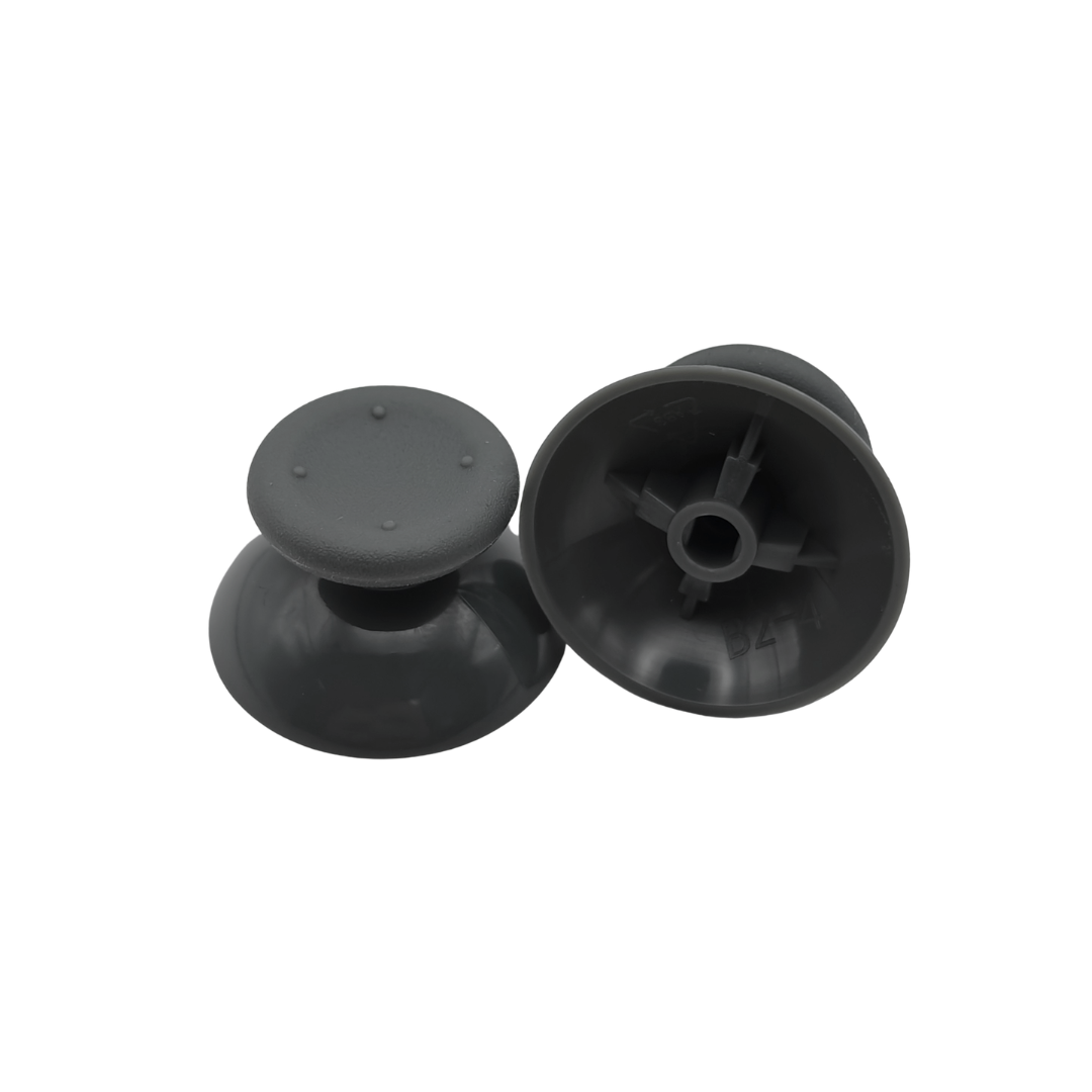 Pair of black controller thumbsticks, with one shown upright and the other showing the underside attachment socket on a white background