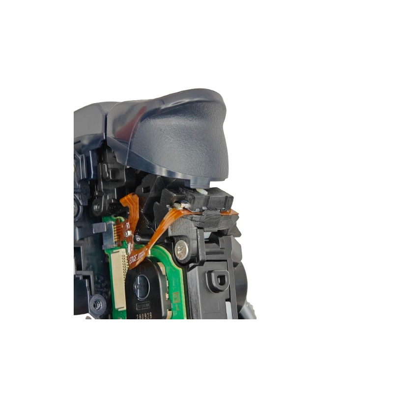 Close-up of the inside of a controller showing a gray trigger, black plastic housing, orange ribbon cable, green circuit board, and screw on a transparent background