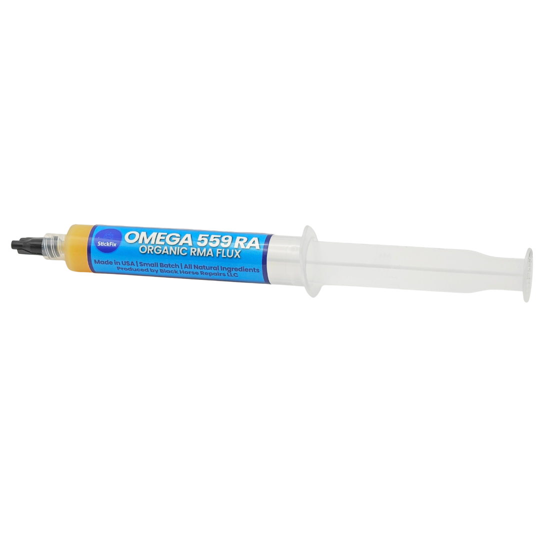 Single syringe of yellow flux paste with a blue label and black tip on a white background