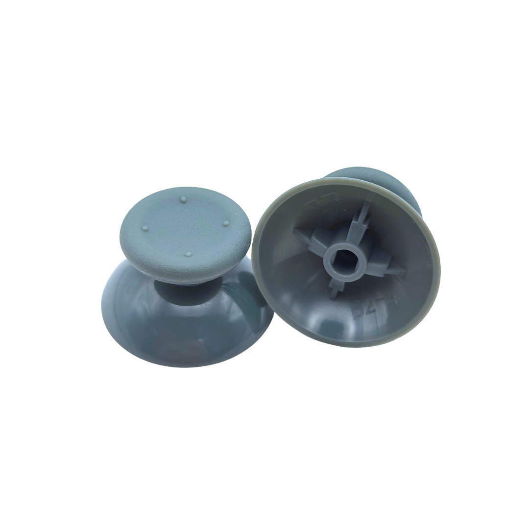 Pair of gray controller thumbsticks, with one shown upright and the other showing the underside attachment socket on a white background
