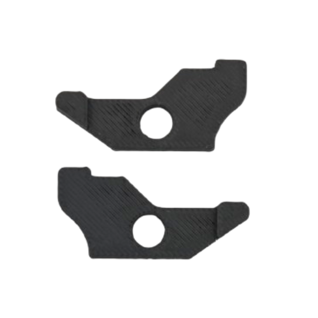 Two black plastic pieces with circular cutouts on a white background