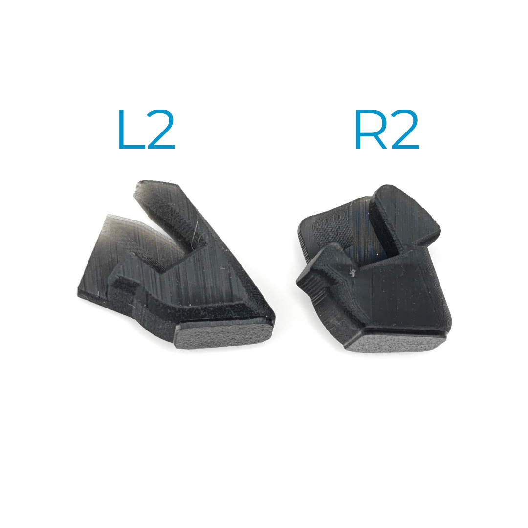 Two black plastic trigger pieces labeled “L2” and “R2” on a white background