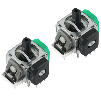 Pair of joystick modules with black center posts, silver metal frames, green side housings, gray plastic parts, and small metal pins on a white background