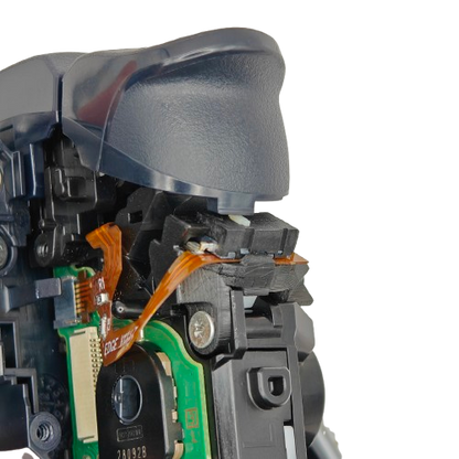 Close-up of the inside of a PS5 DualSense Edge controller showing the trigger assembly, ribbon cable, circuit board