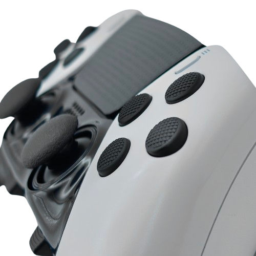 Close-up of a white and black controller with textured black face buttons on a transparent background