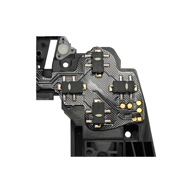 Close-up of a black and silver internal controller circuit board with several small black switch components and gold contact points on a transparent background