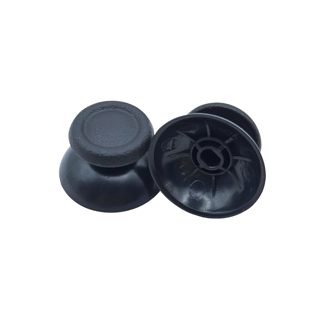 Pair of black controller thumbsticks, with one shown upright and the other showing the underside attachment socket on a white background