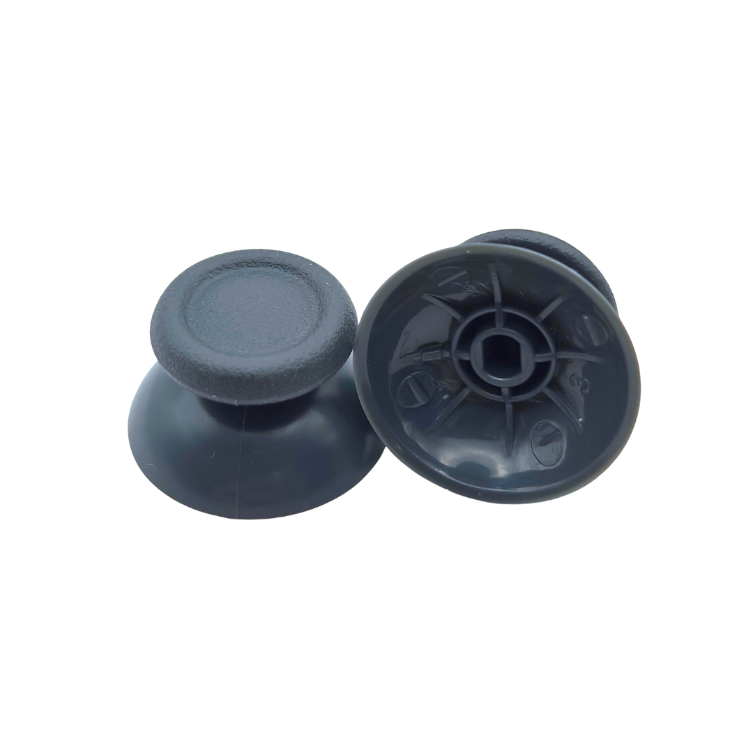 Pair of gray controller thumbsticks, with one shown upright and the other showing the underside attachment socket on a white background