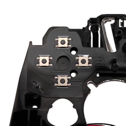 Close-up of the inside of a controller showing four small square button switches on a black internal circuit board against a transparent background