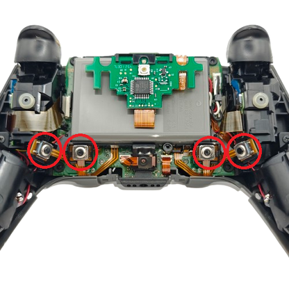 Inside of a PS5 SCUF controller showing the internal button assemblies, circuit board, ribbon cables, and four contact points circled in red